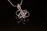 Dimensional atom pendant in sterling silver with crystal center, includes a silver chain,