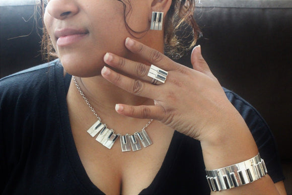 Piano earrings necklace ring and Bangle Jewelry set Sterling silver with 14kt gold music symbol accents. Moi Magazine