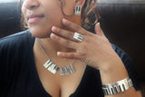 Piano earrings necklace ring and Bangle Jewelry set Sterling silver with 14kt gold music symbol accents. Moi Magazine