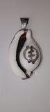 Cowrie shell pendant featuring a sterling silver Adinkra symbol known as Gye Nyame.