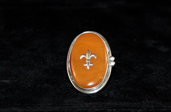 Fleur de lis Amber ring Handmade by New Orleans artist Chester Allen one of a kind in Butterscotch amber stone set in Sterling silver