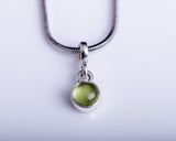 Peridot charm necklace, sterling silver, green circle pendant, September birthstone